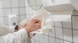 A person drying their hands with paper towels.